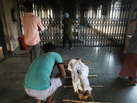 Tumpa Das, age 29, opens the gate for cremating a dead body in a furnace inside a crematorium in the Baruipur Panchayat area in South 24-Par...