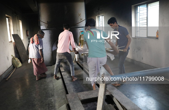 Tumpa Das, age 29, prepares a dead body for cremation in a furnace inside a crematorium in the Baruipur Panchayat area in South 24-Pargana d...