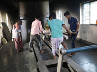 Tumpa Das, age 29, prepares a dead body for cremation in a furnace inside a crematorium in the Baruipur Panchayat area in South 24-Pargana d...