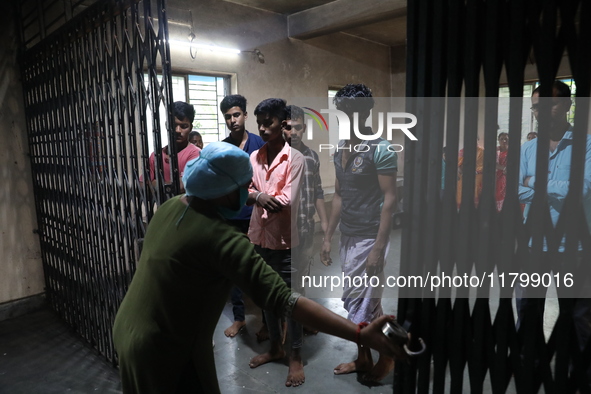 Tumpa Das, age 29, closes the gate before cremating a dead body in a furnace inside a crematorium in the Baruipur Panchayat area in South 24...