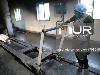 Tumpa Das, age 29, prepares a dead body for cremation in a furnace inside a crematorium in the Baruipur Panchayat area in South 24-Pargana d...