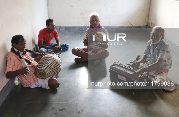 Singers perform a devotional song while Tumpa Das, age 29, a woman Dom, cremates a dead body in a furnace inside a crematorium in the Baruip...