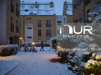 A man shovels snow in a residential neighbourhood in Warsaw, Poland on 22 November, 2024. It is the first time in recent years significant s...