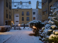 A man shovels snow in a residential neighbourhood in Warsaw, Poland on 22 November, 2024. It is the first time in recent years significant s...