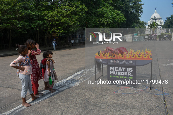 Activists of People for the Ethical Treatment of Animals (PETA) are seen drenched in fake blood and sleep on a figurative oven as they stage...