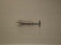 A man rows his boat in the waters of Dal Lake amid fog in Srinagar, Jammu and Kashmir, on November 22, 2024. (