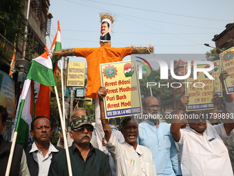 Supporters of India's main opposition Congress party take part in a protest rally with an effigy against the Indian billionaire businessman...