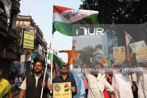 Supporters of India's main opposition Congress party take part in a protest rally with an effigy against the Indian billionaire businessman...