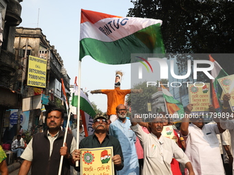 Supporters of India's main opposition Congress party take part in a protest rally with an effigy against the Indian billionaire businessman...