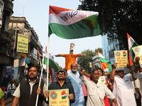 Supporters of India's main opposition Congress party take part in a protest rally with an effigy against the Indian billionaire businessman...