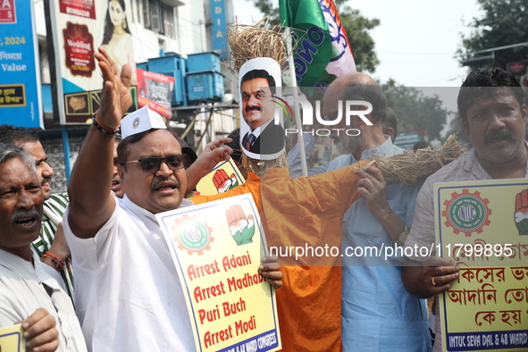 Supporters of India's main opposition Congress party take part in a protest rally with an effigy against the Indian billionaire businessman...