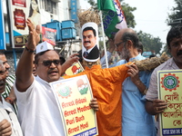 Supporters of India's main opposition Congress party take part in a protest rally with an effigy against the Indian billionaire businessman...