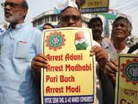 Supporters of India's main opposition Congress party participate in a protest rally against the Indian billionaire businessman Gautam Adani...