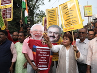 Supporters of India's main opposition Congress party participate in a protest rally against Indian Prime Minister Narendra Modi and billiona...