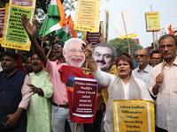 Supporters of India's main opposition Congress party participate in a protest rally against Indian Prime Minister Narendra Modi and billiona...