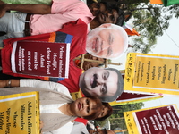 Supporters of India's main opposition Congress party participate in a protest rally against Indian Prime Minister Narendra Modi and billiona...