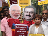 Supporters of India's main opposition Congress party participate in a protest rally against Indian Prime Minister Narendra Modi and billiona...