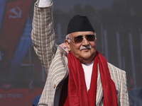 Nepal Prime Minister and chairman of CPN-UML (Communist Party of Nepal- Unified Marxist Leninist) KP Sharma Oli (Center) waves to the crowd...