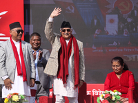 Nepal Prime Minister and chairman of CPN-UML (Communist Party of Nepal- Unified Marxist Leninist) KP Sharma Oli (Center) waves to the crowd...