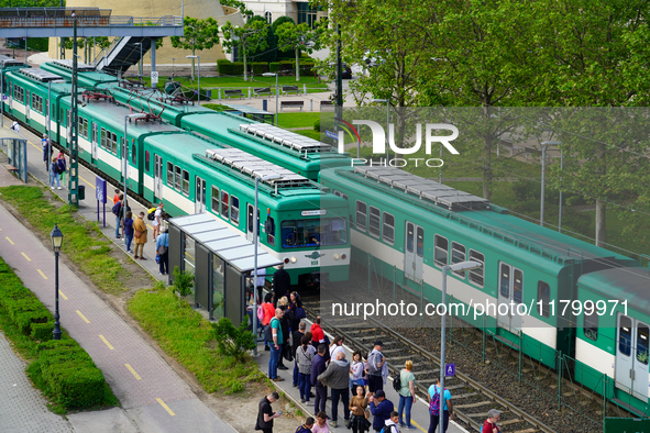 Passengers queue to board the suburban train at the Mupa-Nemzeti Szinhaz station in Budapest, Hungary, on May 19, 2023. The station is locat...