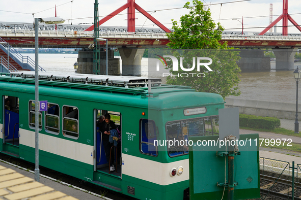 A suburban train halts at Mupa-Nemzeti Szinhaz station in Budapest, Hungary, on May 19, 2023, offering a view of the Danube River and a prom...