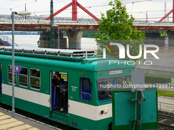 A suburban train halts at Mupa-Nemzeti Szinhaz station in Budapest, Hungary, on May 19, 2023, offering a view of the Danube River and a prom...