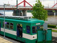 A suburban train halts at Mupa-Nemzeti Szinhaz station in Budapest, Hungary, on May 19, 2023, offering a view of the Danube River and a prom...