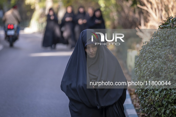 A veiled Iranian woman walks along a street while arriving to take part in an anti-Israeli rally in front of the United Nations (UN) office...