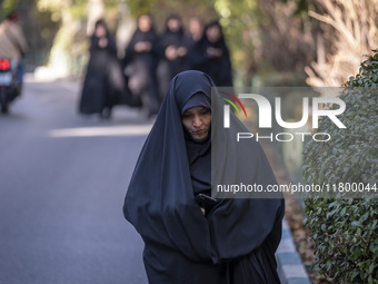 A veiled Iranian woman walks along a street while arriving to take part in an anti-Israeli rally in front of the United Nations (UN) office...