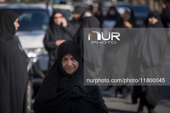 Veiled Iranian women walk along a street after participating in an anti-Israeli rally in front of the United Nations (UN) office in northern...