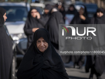 Veiled Iranian women walk along a street after participating in an anti-Israeli rally in front of the United Nations (UN) office in northern...