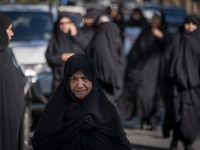 Veiled Iranian women walk along a street after participating in an anti-Israeli rally in front of the United Nations (UN) office in northern...