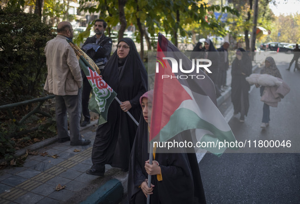 A veiled Iranian girl carries a Palestinian flag while participating in an anti-Israeli rally in front of the United Nations (UN) office in...