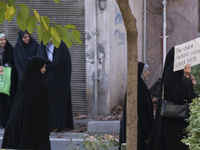 A veiled Iranian woman carries an anti-UN placard while arriving to participate in an anti-Israeli rally in front of the United Nations offi...