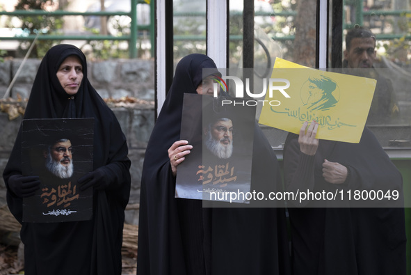 Veiled Iranian women hold portraits of Lebanon's Hezbollah leader, Hassan Nasrallah, during an anti-Israeli rally in front of the United Nat...