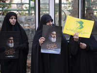 Veiled Iranian women hold portraits of Lebanon's Hezbollah leader, Hassan Nasrallah, during an anti-Israeli rally in front of the United Nat...