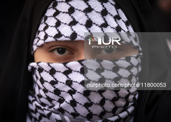 A veiled young Iranian girl wears a Palestinian scarf while participating in an anti-Israeli rally in front of the United Nations (UN) offic...