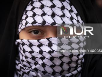 A veiled young Iranian girl wears a Palestinian scarf while participating in an anti-Israeli rally in front of the United Nations (UN) offic...