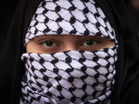 A veiled young Iranian girl wears a Palestinian scarf while participating in an anti-Israeli rally in front of the United Nations (UN) offic...