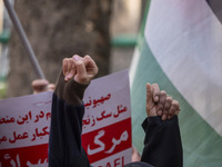 Veiled Iranian women shout anti-UN, anti-U.S., and anti-Israeli slogans during an anti-Israeli rally in front of the United Nations office i...