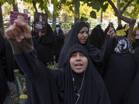 Veiled Iranian women shout anti-UN, anti-U.S., and anti-Israeli slogans during an anti-Israeli rally in front of the United Nations office i...