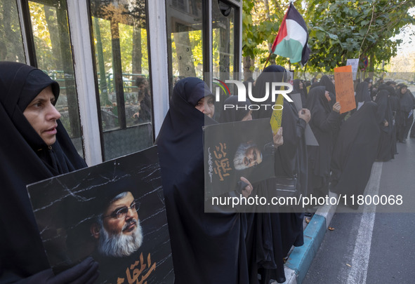 Veiled Iranian women hold portraits of Lebanon's Hezbollah leader, Hassan Nasrallah, during an anti-Israeli rally in front of the United Nat...