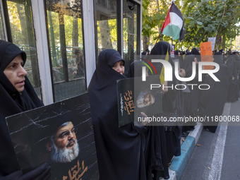 Veiled Iranian women hold portraits of Lebanon's Hezbollah leader, Hassan Nasrallah, during an anti-Israeli rally in front of the United Nat...