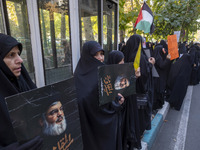 Veiled Iranian women hold portraits of Lebanon's Hezbollah leader, Hassan Nasrallah, during an anti-Israeli rally in front of the United Nat...