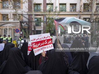 Veiled Iranian women wave a Palestinian flag and hold up an anti-U.S. placard during an anti-Israeli rally in front of the United Nations of...