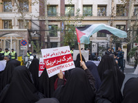 Veiled Iranian women wave a Palestinian flag and hold up an anti-U.S. placard during an anti-Israeli rally in front of the United Nations of...