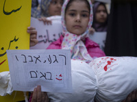 A young veiled girl holds an anti-Israeli placard that reads, ''Keep waiting, we are coming,'' and a package wrapped in a shroud, symbolizin...