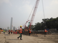 Labourers work at a metro railway station construction site in Kolkata, India, on November 22, 2024. (