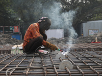 A laborer works at a metro railway station construction site in Kolkata, India, on November 22, 2024. (