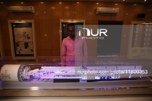 A worker looks at a model of a metro railway station at a construction site in Kolkata, India, on November 22, 2024. 